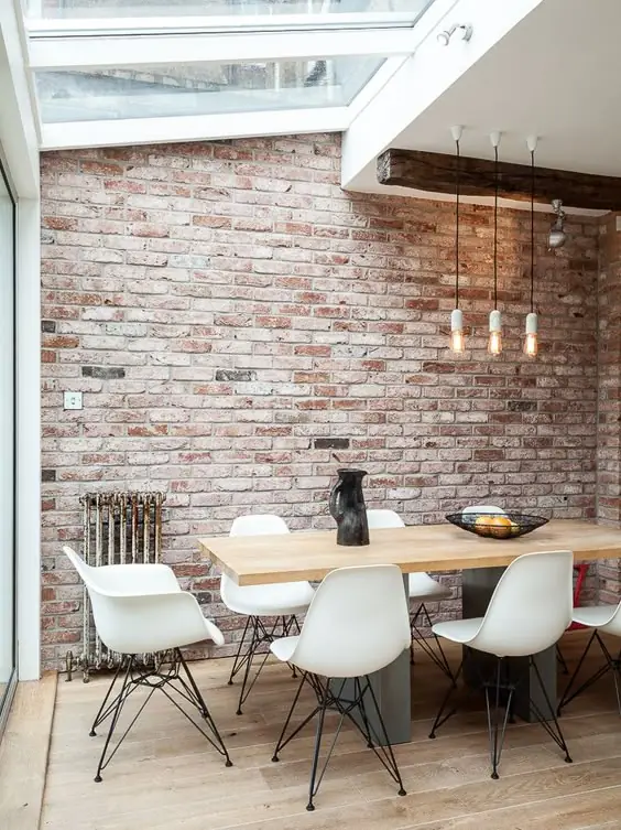 Dining room with a pale reclaimed brick accent wall
