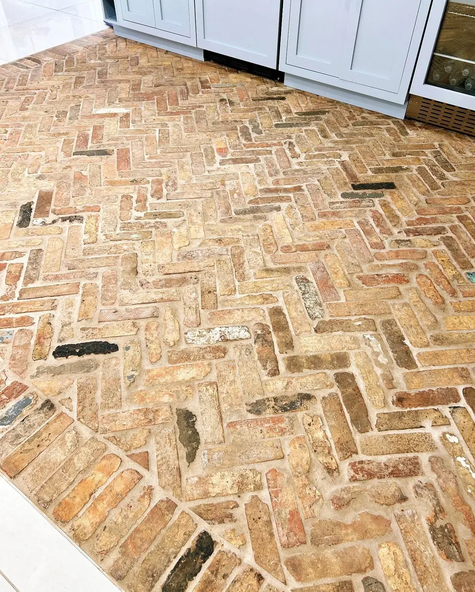 Reclaimed brick floor laid in a herringbone pattern