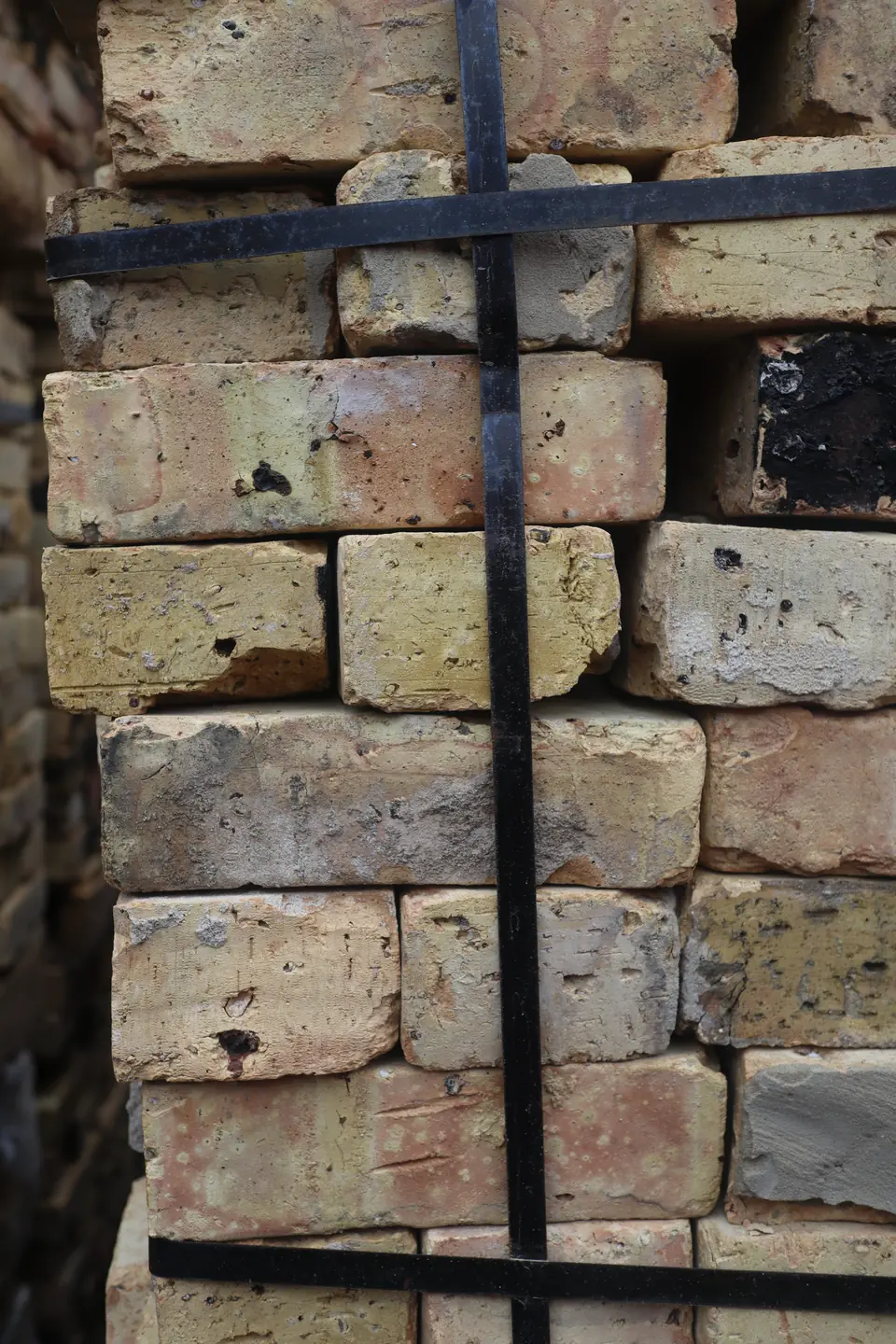 Close-up of mixed reclaimed Chicago brick in buff, tan and gray tones